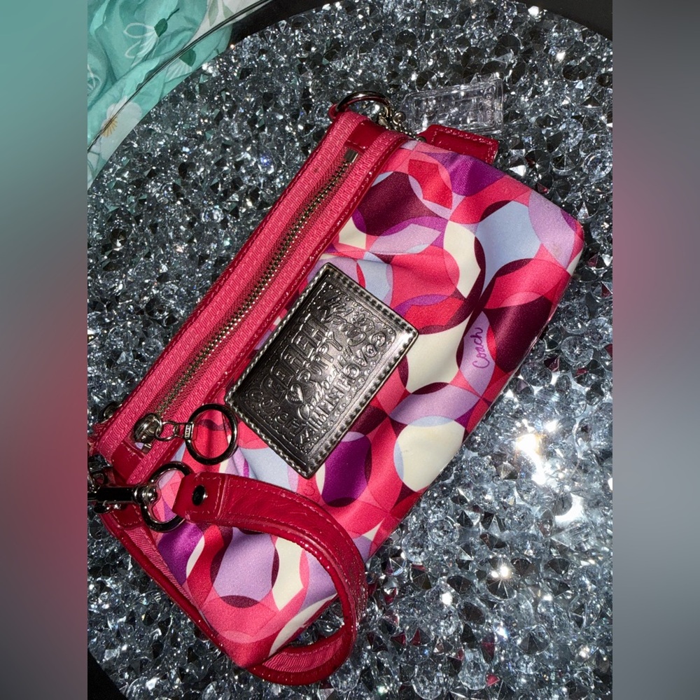 Coach Poppy Wristlet featuring a pink and purple geometric pattern. - Picture 2 of 9